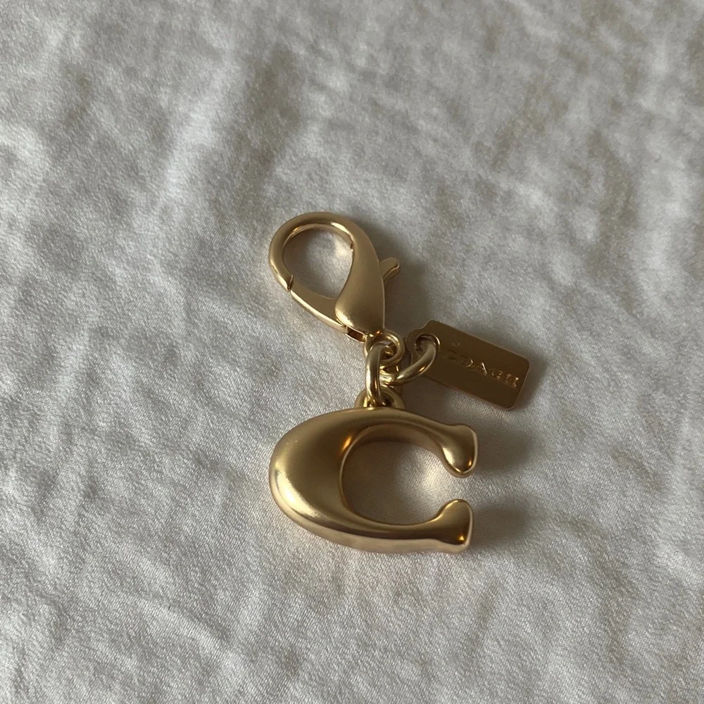 Coach: Metallic Gold Tone Key Holder Charm